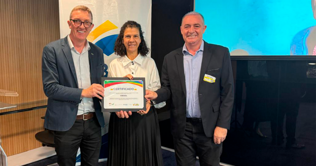 Certificado entregue pela presidente da ABDE e diretora do BNDES, Maria Fernanda Coelho, ao presidente Cledir e vice-presidente Adriano.